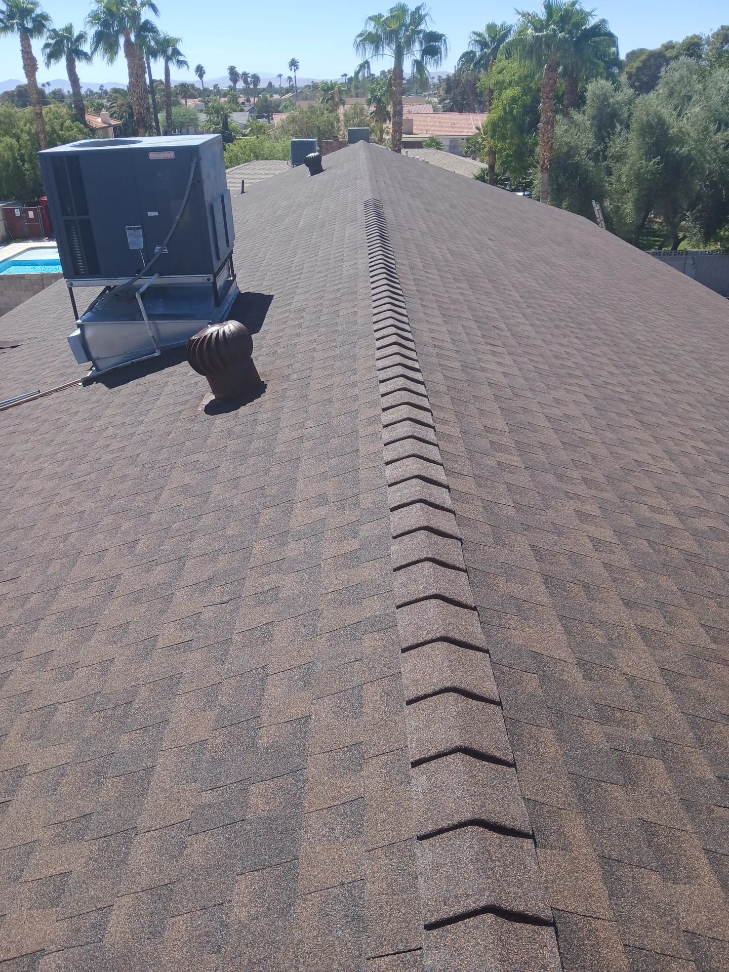 Brown shingle roof with ridge caps finished by Lopez Roofing