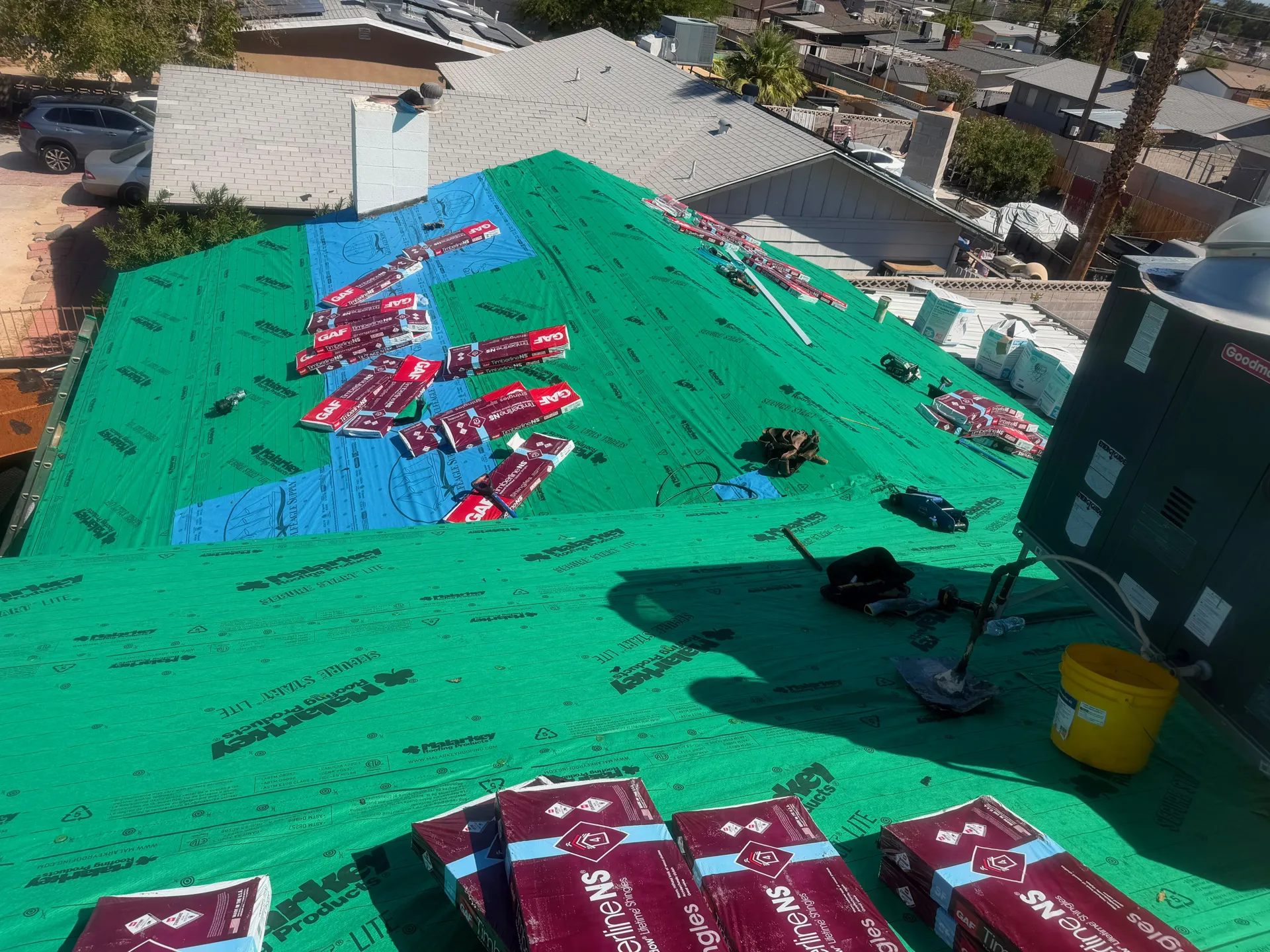 Synthetic underlayment installed with GAF shingle bundles ready