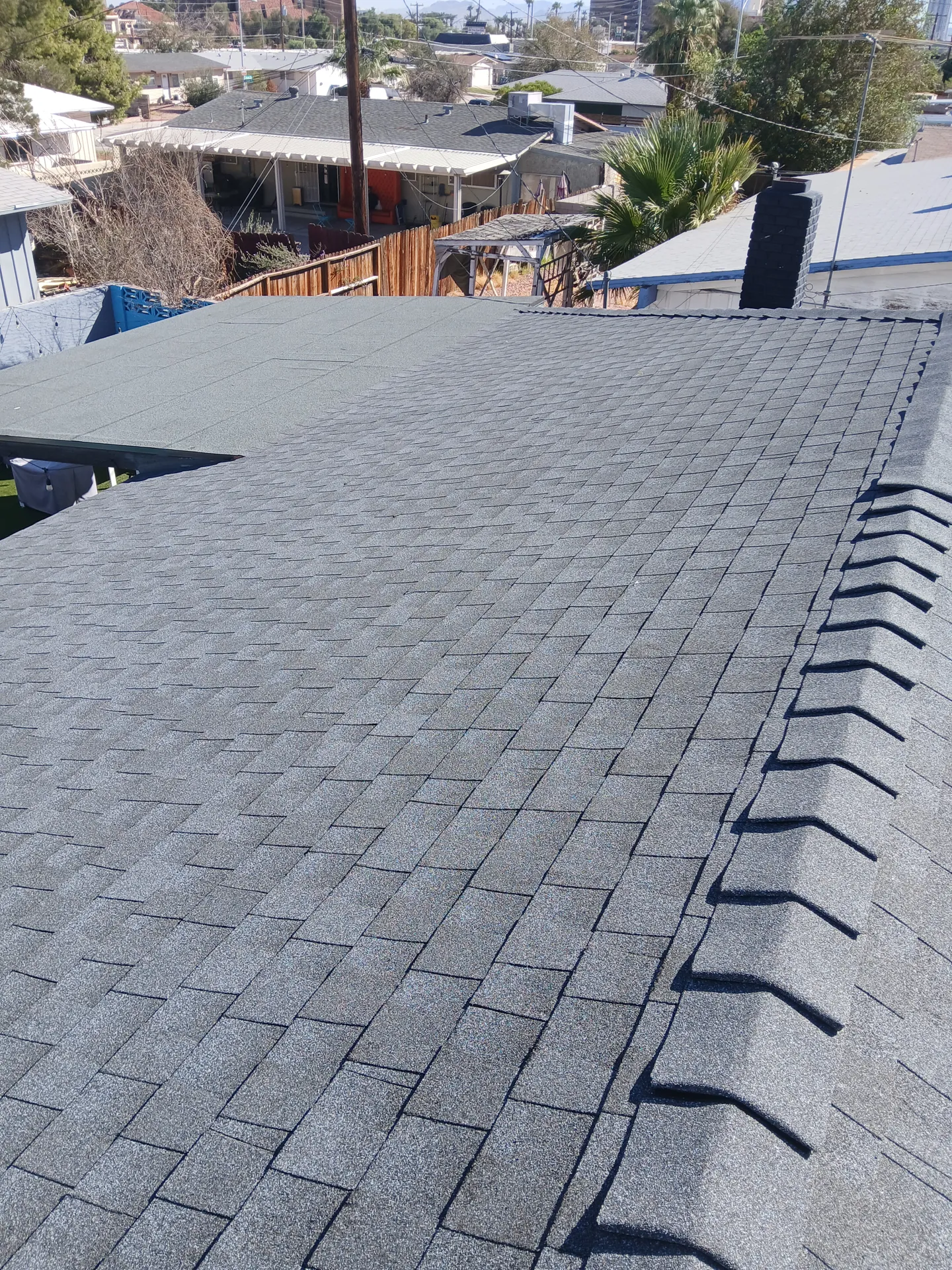 Finished shingle roof with ridge caps